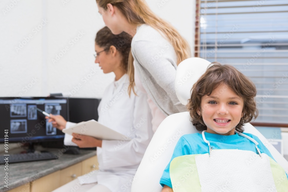Obraz premium Little boy smiling at camera at dentists