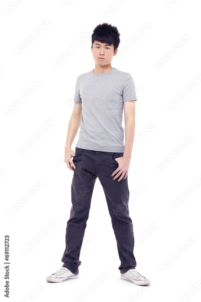 young man standing with hands in pockets posing young man standing with hands in pockets posing