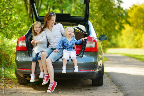 Happy family of three going to a car vacation © MNStudio
