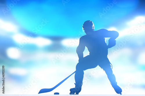 Hockey player skating with a puck in arena lighs