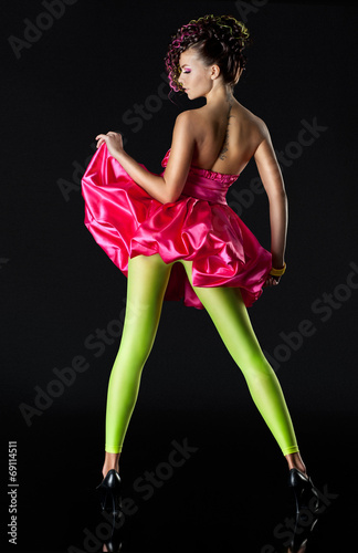 Young woman in green tights and a red short dress