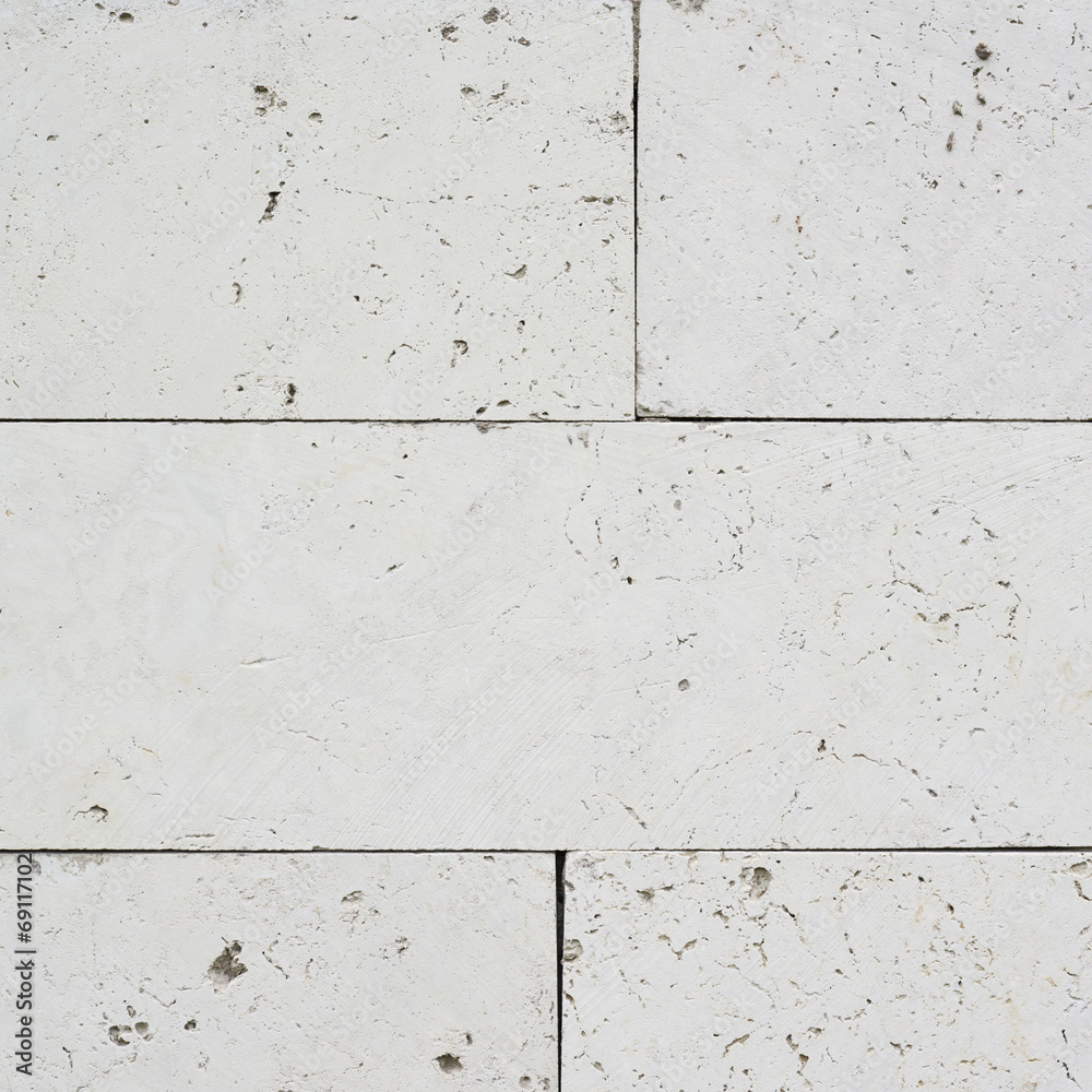 Naklejka premium White limestone brick wall's fragment