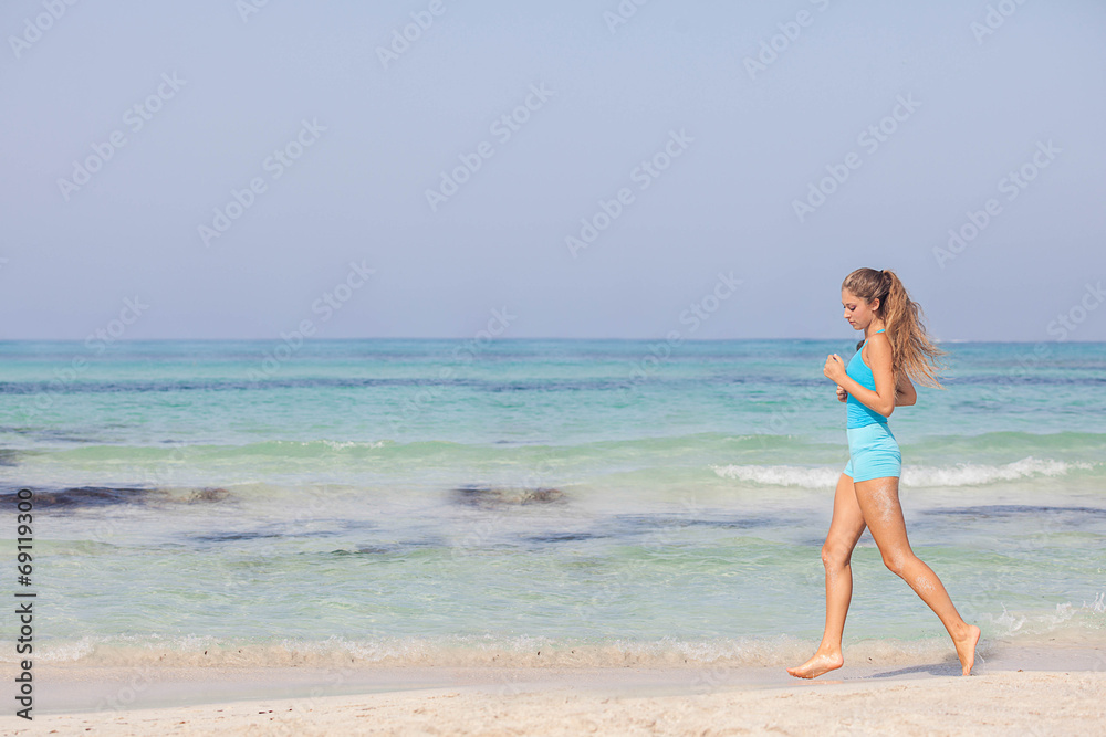fit healthy woman jogging or running on seashore