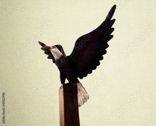 Eagles wood Statue on vintage blackground photo