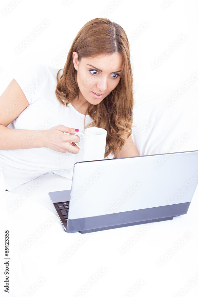 portrait of confused and surprised woman using laptop drinking c portrait of confused and surprised woman using laptop drinking c