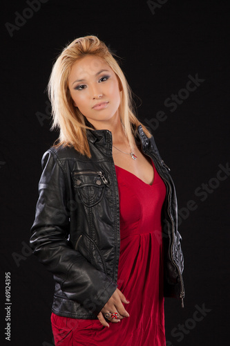 Blond woman in black leather jacket, looking serious