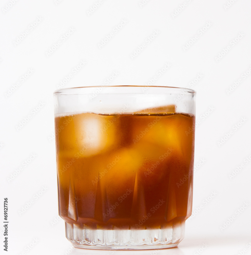 glass with ice tea full with ice cubes on white background glass with ice tea full with ice cubes on white background