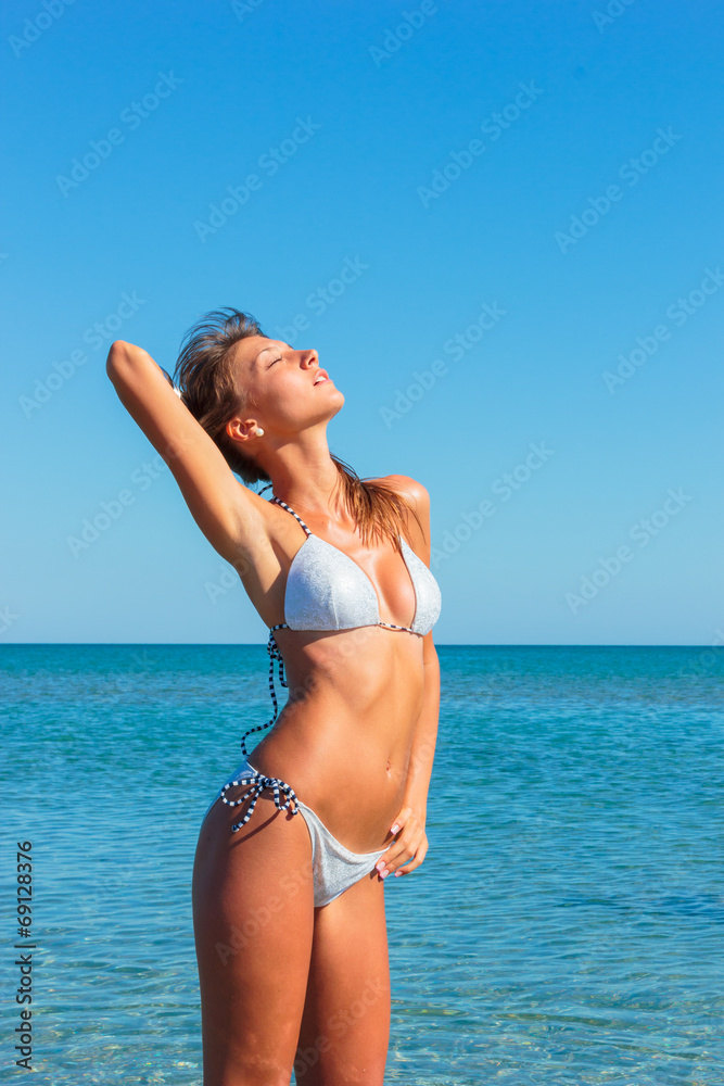woman in bikini, outdoor on the beach woman in bikini, outdoor on the beach