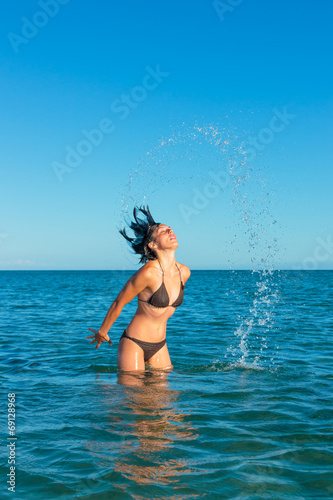 Motion freeze of a girl splashing with her hair