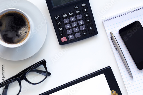 Workplace, coffee and diary with calculator