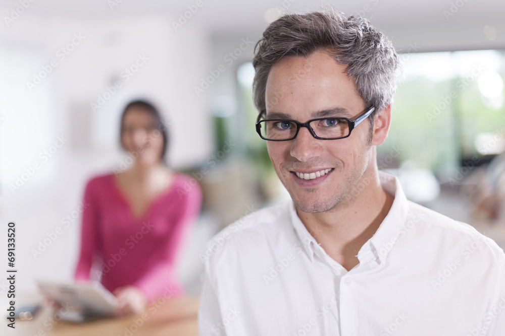 couple at home man at foreground looking at camera couple at home man at foreground looking at camera