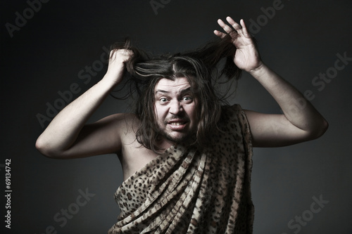 Wildman in leopard skin touch hair