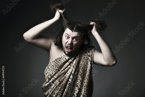 Wildman in leopard skin touch hair