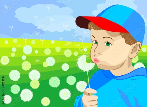 a little boy blowing on a dandelion in the meadow