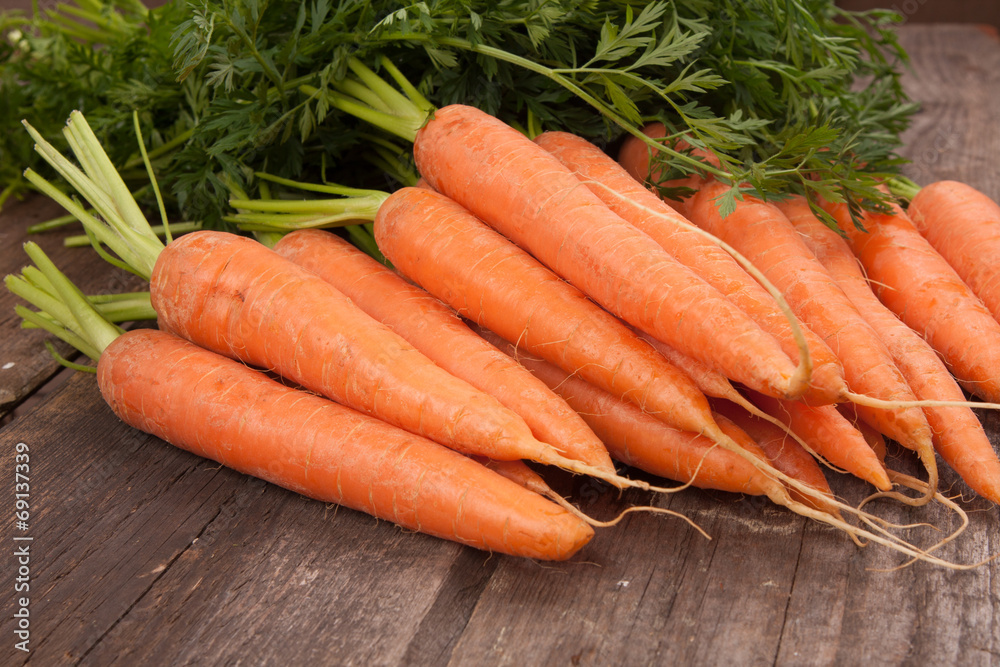 fresh carrot bunch on grungy wooden background fresh carrot bunch on grungy wooden background