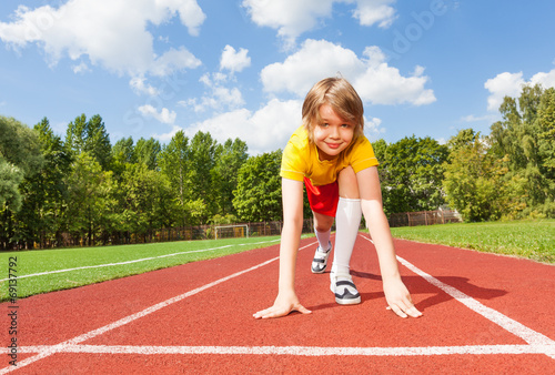 Boy ready to run on road looking straight