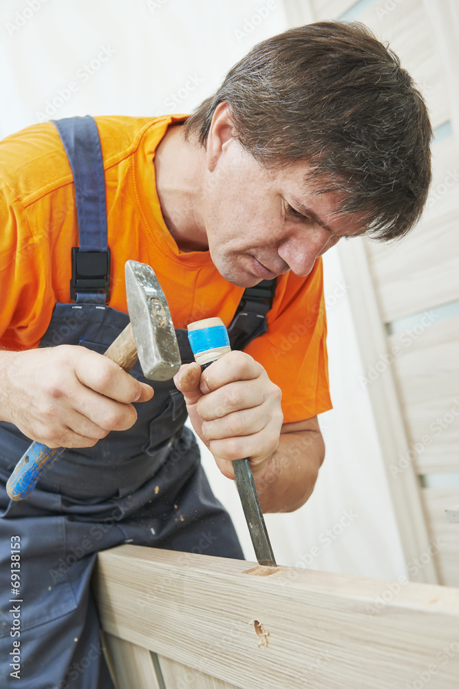 Carpenter works with hummer and chisel Carpenter works with hummer and chisel