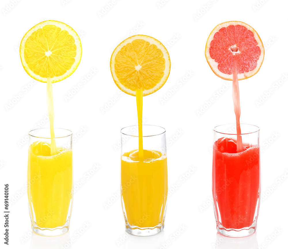 Juice pouring from fruits into glass, isolated on white Juice pouring from fruits into glass, isolated on white