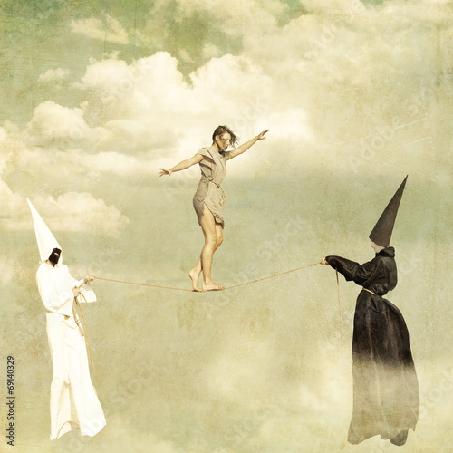 Foto Woman walking along a tightrope held by two mysterious persons