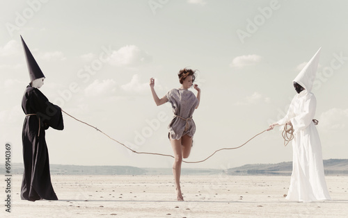 Photos Woman hoping over the rope held by two mysterious persons