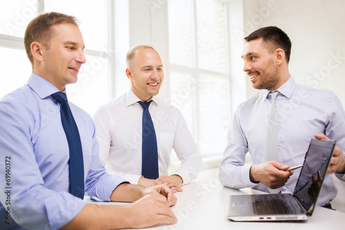 smiling businessmen having discussion in office