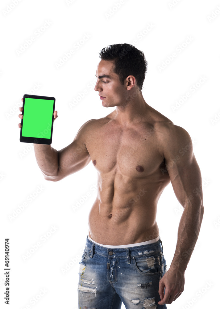 Fototapeta premium Sexy muscular shirtless young man holding a blank tablet PC