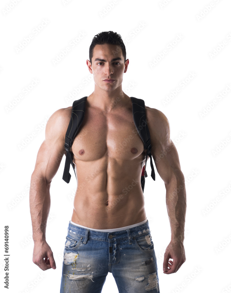 Shirtless muscular young man with backpack on his back Shirtless muscular young man with backpack on his back