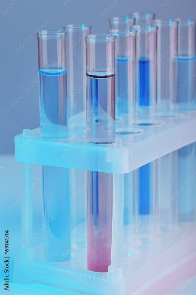 Test tubes with liquid on grey background