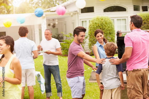 фотографія Multi Generation Family Enjoying Party In Garden Together