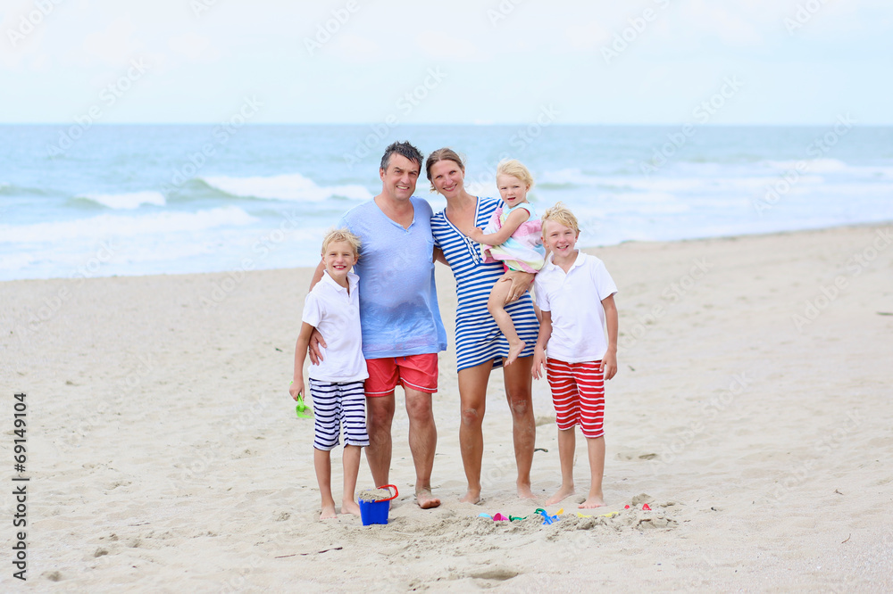 Happy family of five enjoying vacation on the beach Happy family of five enjoying vacation on the beach