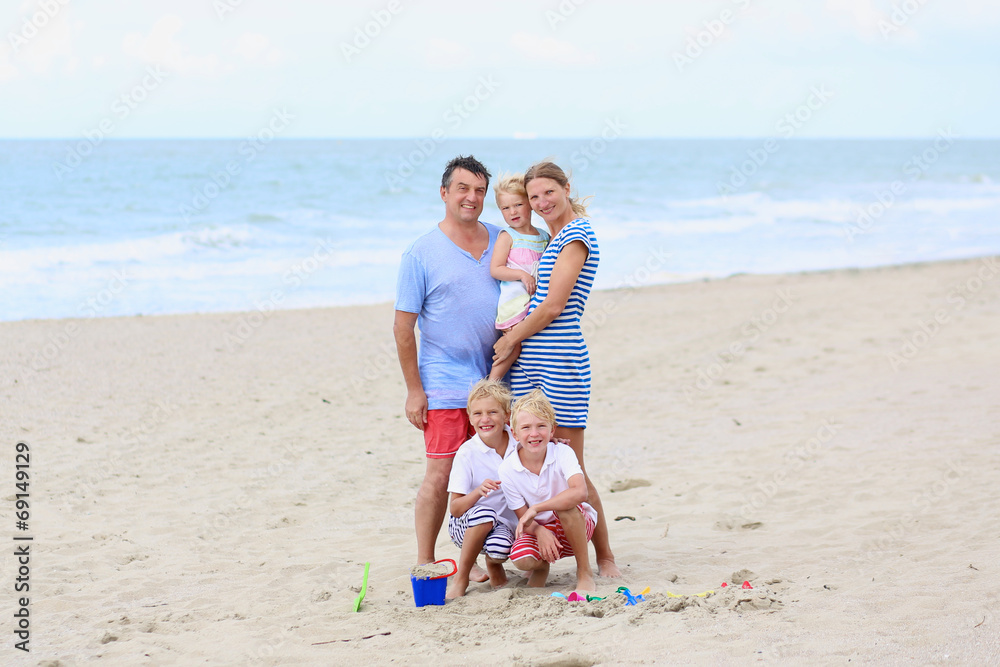 Happy family of five enjoying vacation on the beach Happy family of five enjoying vacation on the beach