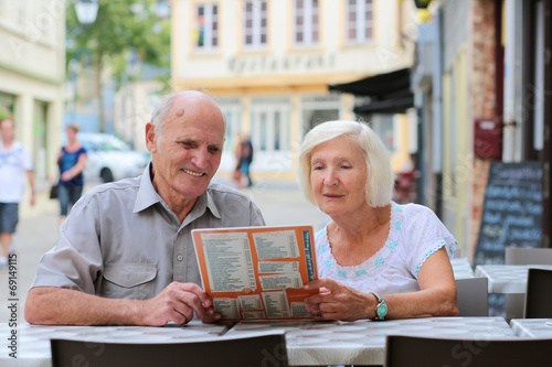 Senior couple relaxing in outdoors cafe