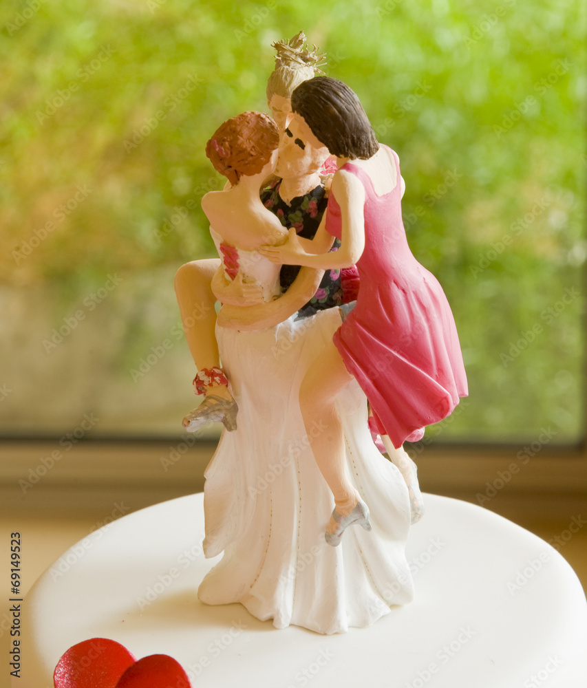 Wedding Cake Topper Depicting One Man with Several Women Stock Photo |  Adobe Stock