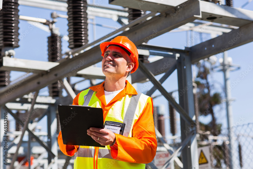 middle aged electrical engineer with clipboard middle aged electrical engineer with clipboard