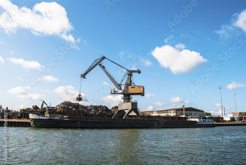 Harbor - crane loading a ship with scrap metal