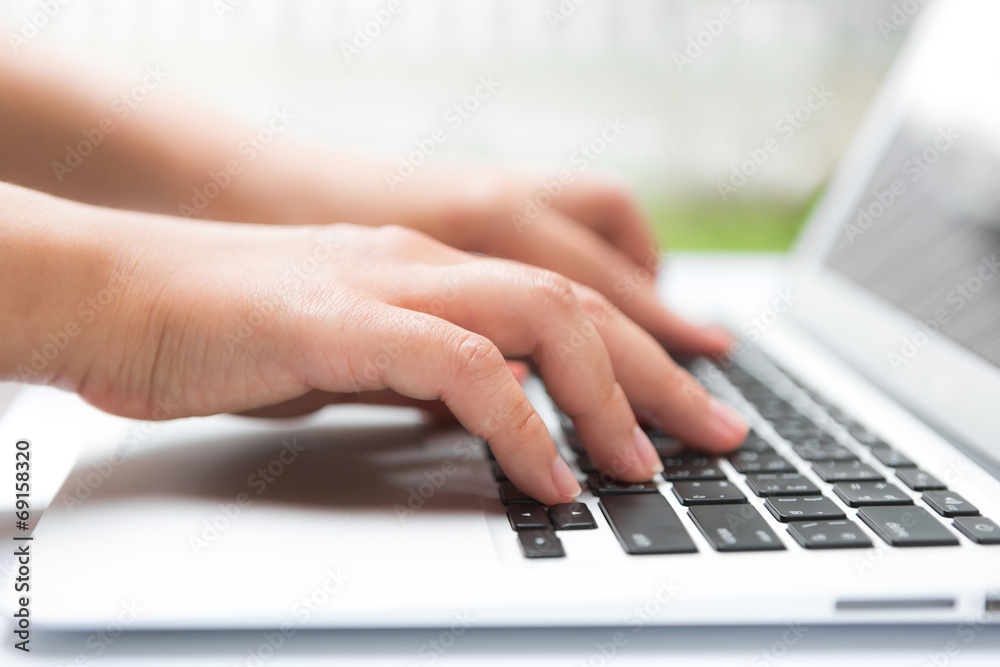Closeup of business woman hand typing on laptop keyboard Closeup of business woman hand typing on laptop keyboard