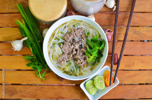 Vietnamese pho on wood table. Pho is a vietnamese traditional photo