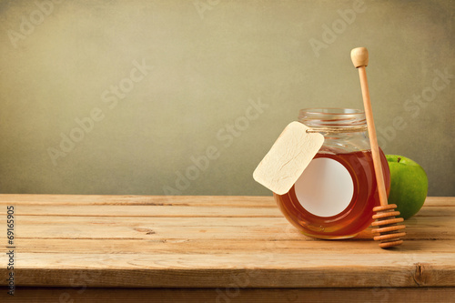 Honey and apple on wooden table with copy space