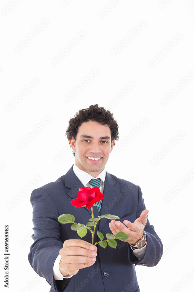 Young businessman holding red rose and offers a rose to the came Young businessman holding red rose and offers a rose to the came