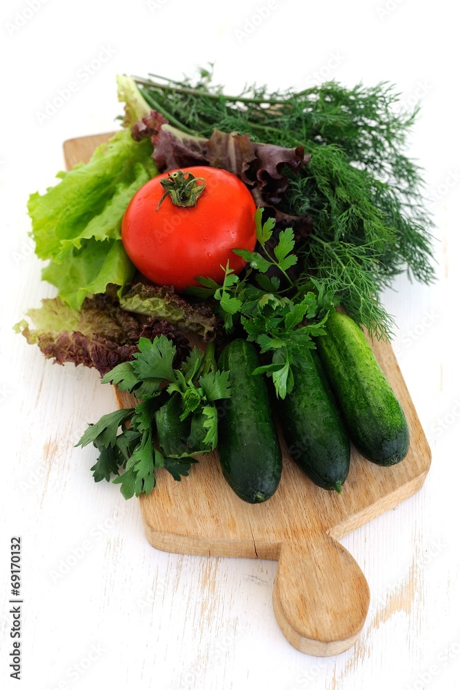 Green cucumbers, tomato and fresh herbs Green cucumbers, tomato and fresh herbs