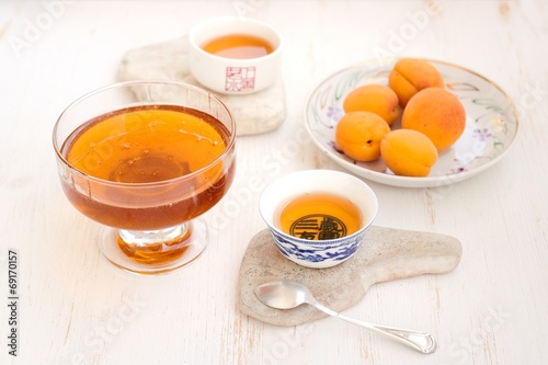 Apricots, honey and tea on a white background