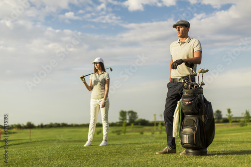 Young couple at golf cart