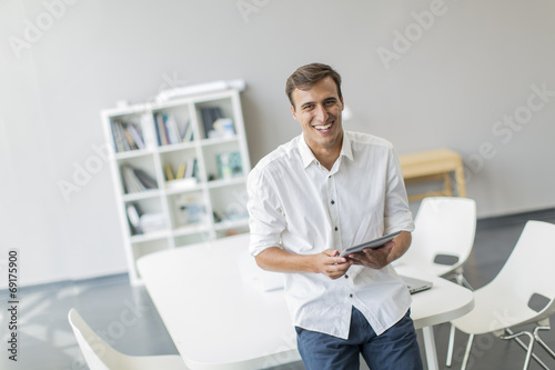 Young man with tablet in th...