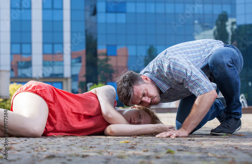 Man checking if woman's breathing