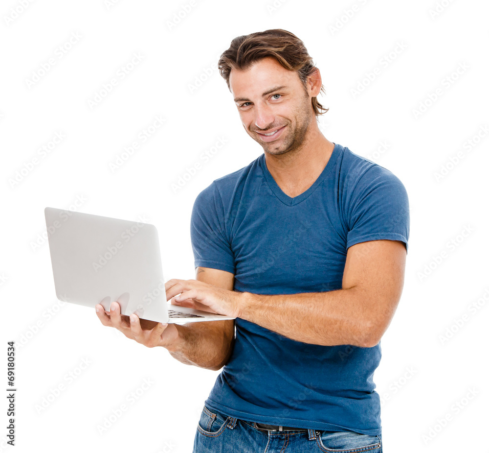 A handsome young man working on his laptop A handsome young man working on his laptop