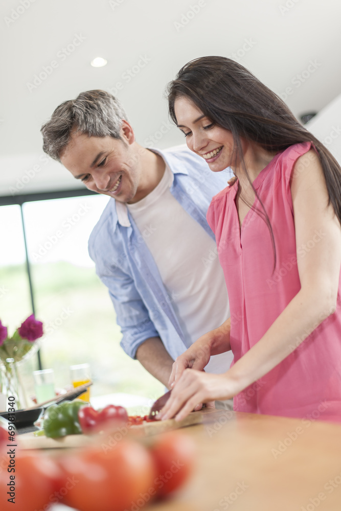 handsome couple cooking in kitchen handsome couple cooking in kitchen