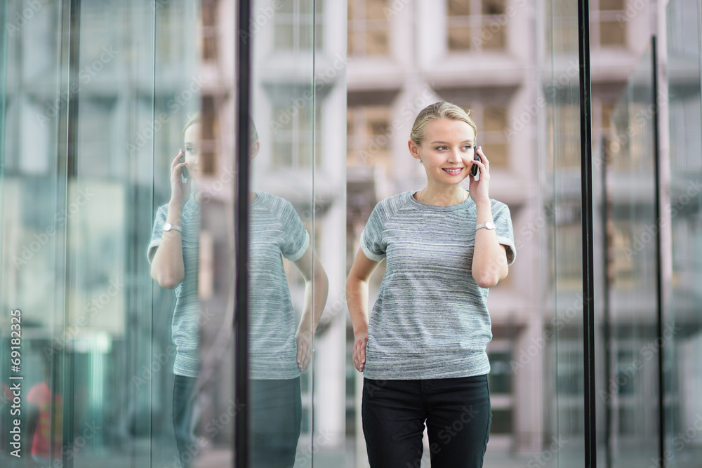 Fototapeta premium Young business woman speaking on the phone