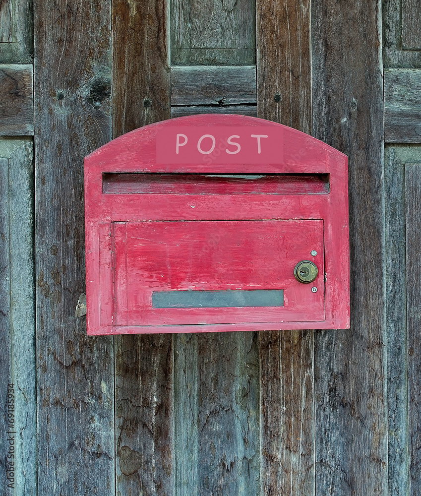 Red wooden mail box on wooden wall