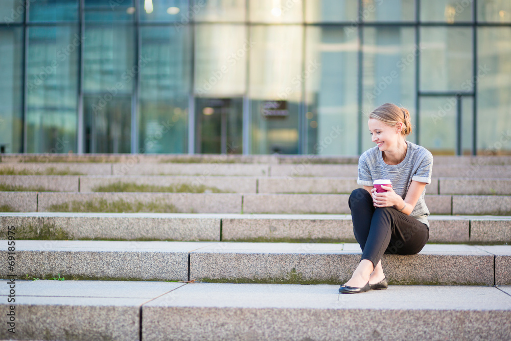 Young beautiful woman having her coffee break Young beautiful woman having her coffee break