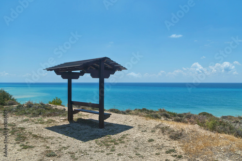 bench with roof facing sea
